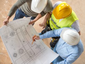 Engineers looking at blueprints